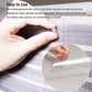 Sticky clear PVC scratch guard sheet being pressed onto sofa fabric by hand