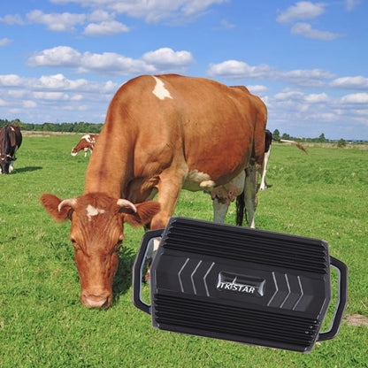 Waterproof GPS pet tracker device, black plastic unit with handle, near farm animals