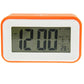 Orange multi-function alarm clock close-up LCD display with time and temperature