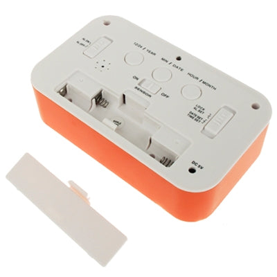 Orange and white multi-function alarm clock rear battery compartment with terminals