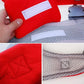 Red baby carrier backpack close-up of padded panels and adjustable gray webbing