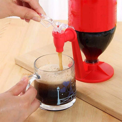 Red inverted soda bottle fizz dispenser with clear spout, pouring into a glass
