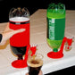Red inverted drink dispenser on countertop with clear spout and bottle attachment