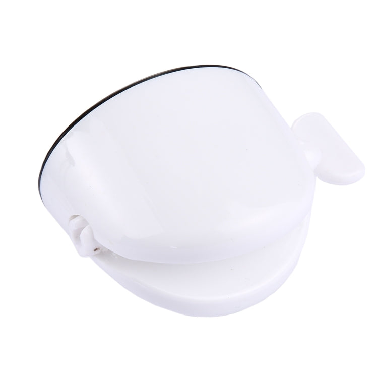 White toothpaste squeezer with black-trim rim, curved dome, and side lever