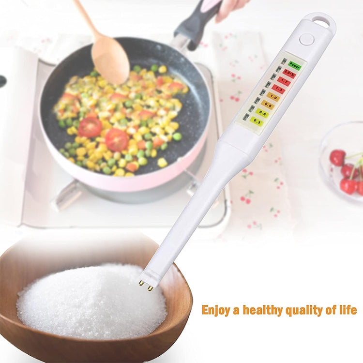 Salinity tester probe measuring salt crystals from a wooden spoon