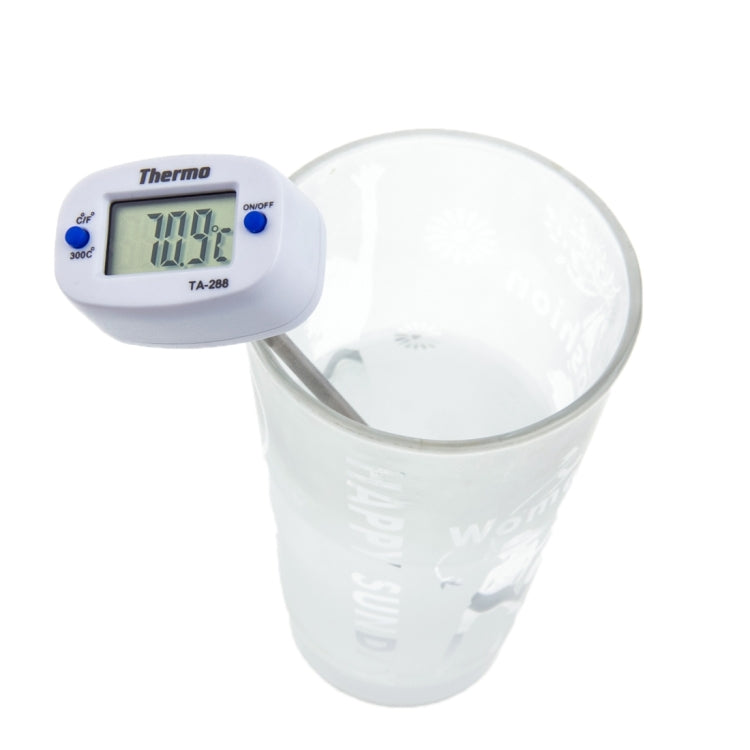Digital thermometer with LCD display and long metal probe clipped to mug