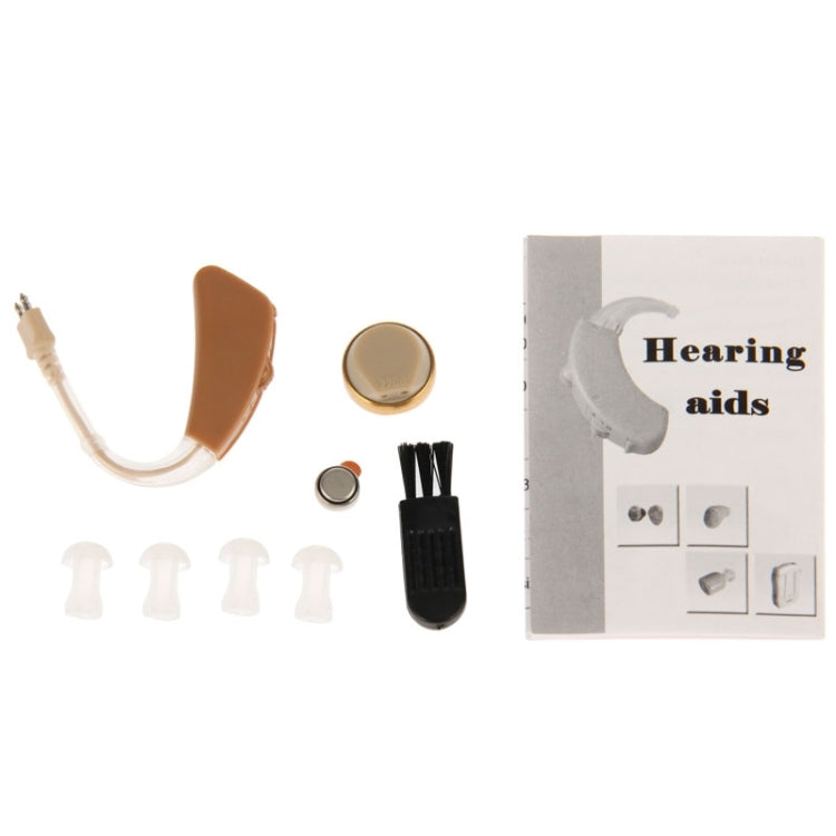 Hearing aid kit with beige device, spare ear tips, and small cleaning tool pieces