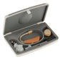 Open hearing aid case with beige device, clear tubing, white ear tips, and accessory tool