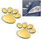 Gold 3D paw print car stickers, four small prints and one large paw on cover