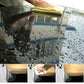 Car wash chamois towel in use, yellow towel wiping a wet car window surface