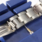 Watch strap adjuster tool pressing a metal bracelet link
