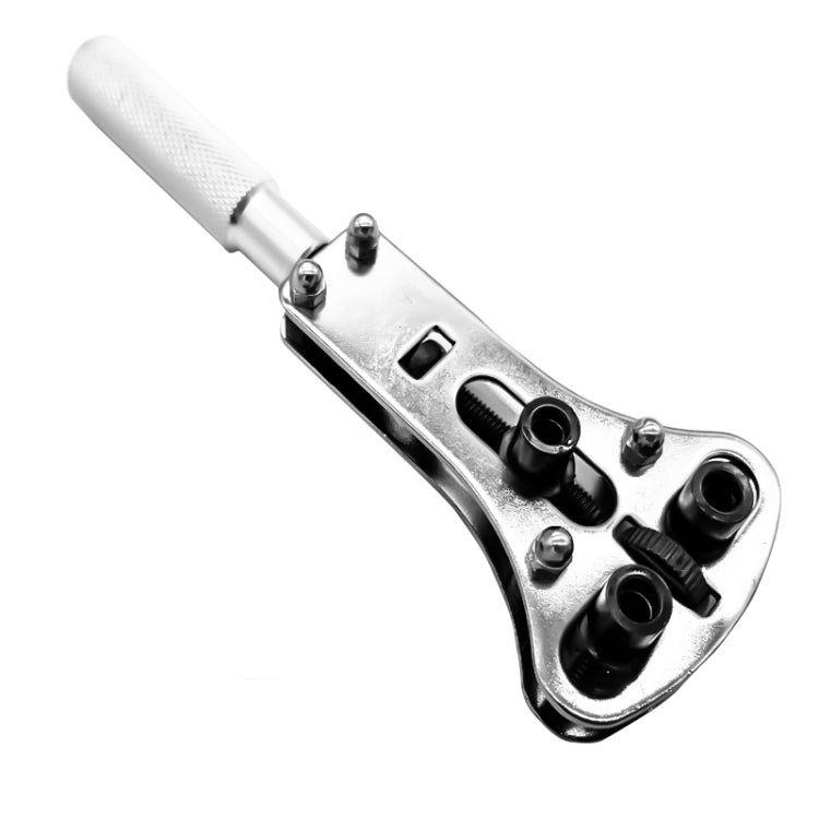 Metal watch case opener with textured grip and removable-style bits in tray