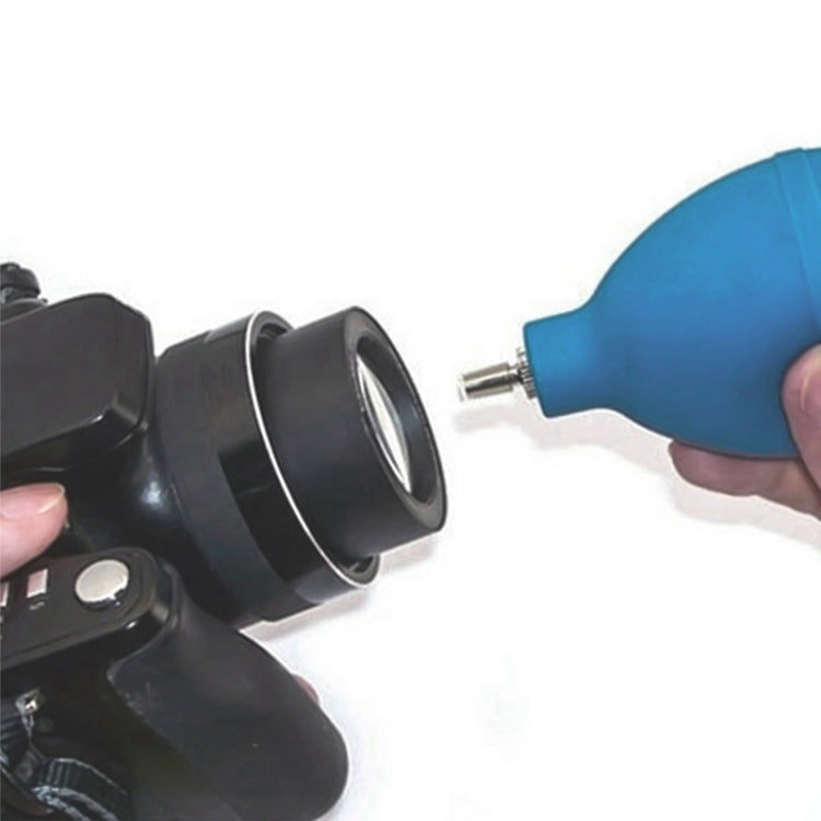 Air blower nozzle cleaning a black watch case head with blue rubber bulb
