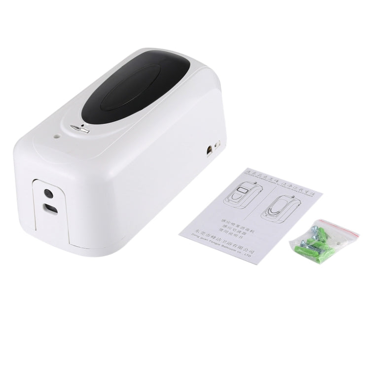 White touchless liquid soap dispenser with included paper manual and small accessory items