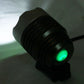 Bicycle headlamp light showing a glowing green LED from a black front housing