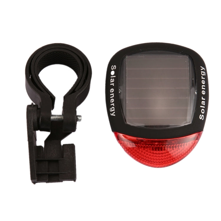Solar bicycle tail light with mounting strap and red lens solar panel face
