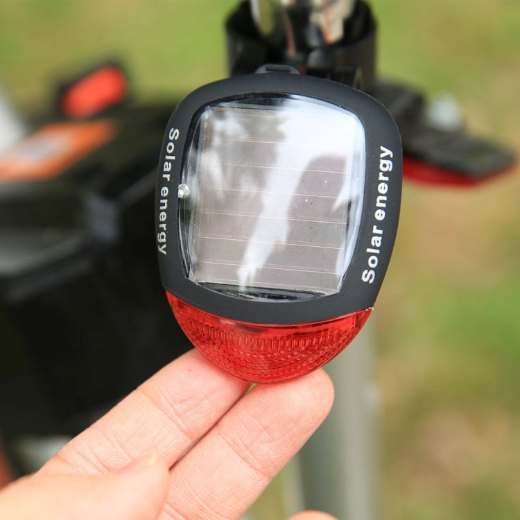 Solar bicycle tail light close-up with solar panel window and red lens