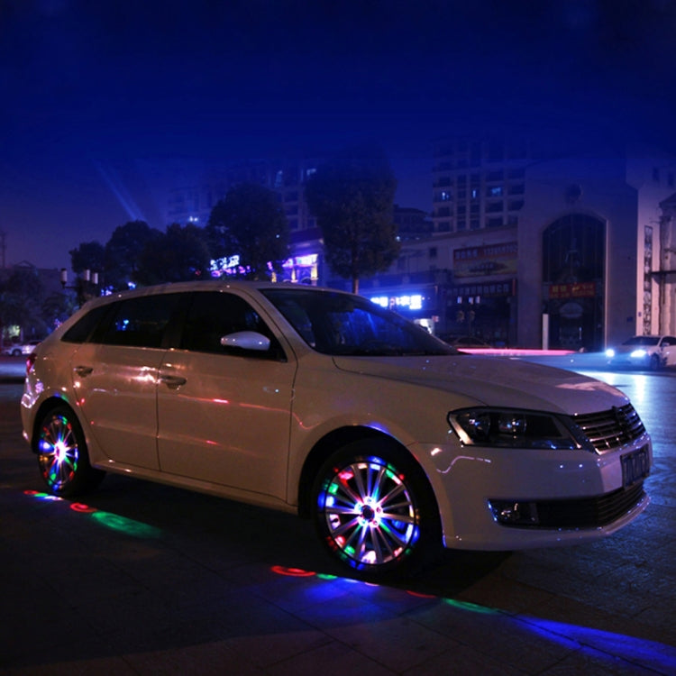 Car with solar wheel LED lights flashing multicolor around the rims
