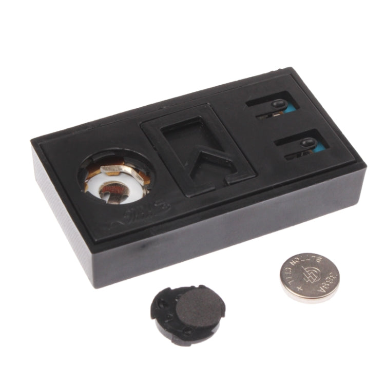 Car clock display internal parts: black circuit base and small round sensor