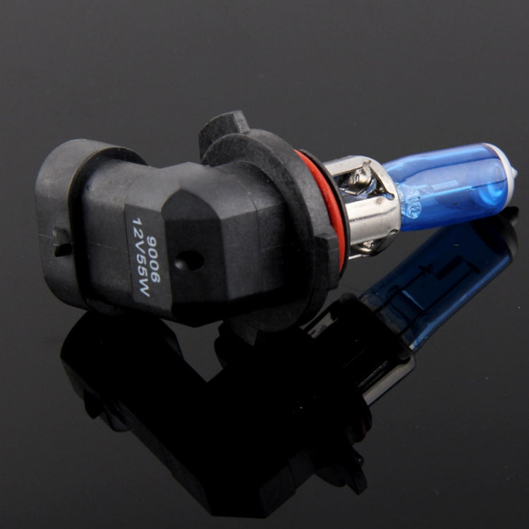 Halogen headlight bulb close-up with blue glass tube and black socket housing