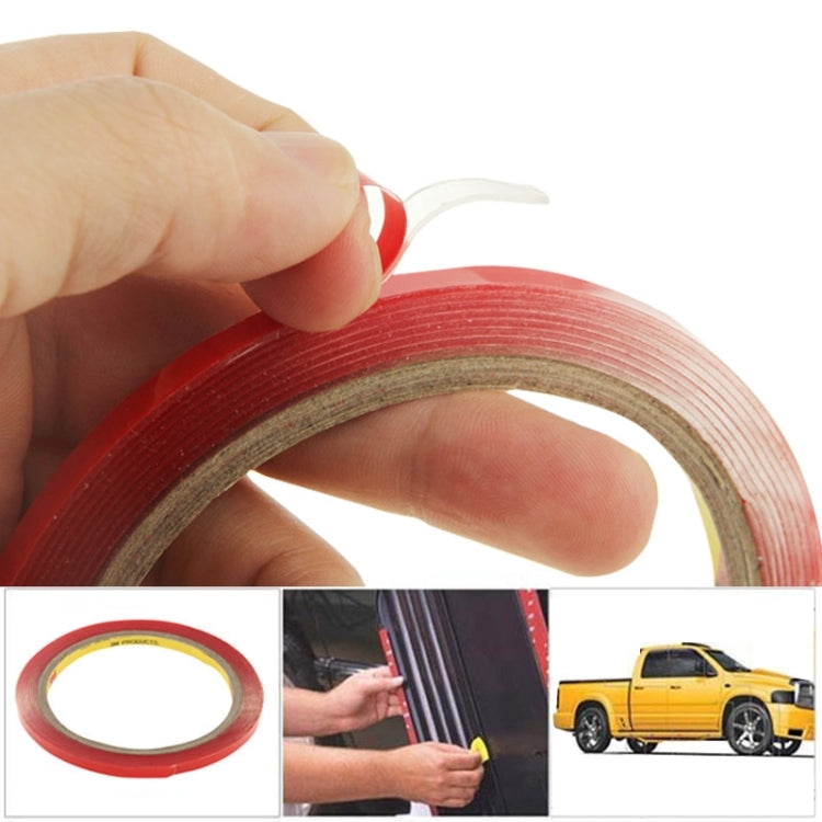 Double-sided adhesive tape roll with red backing, held by hand