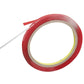 Coiled red double-sided adhesive tape with backing strip extending