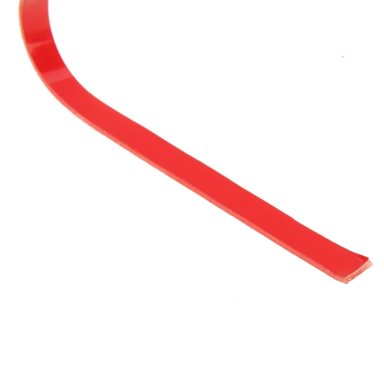 Red double-sided adhesive tape strip with protective liner edge