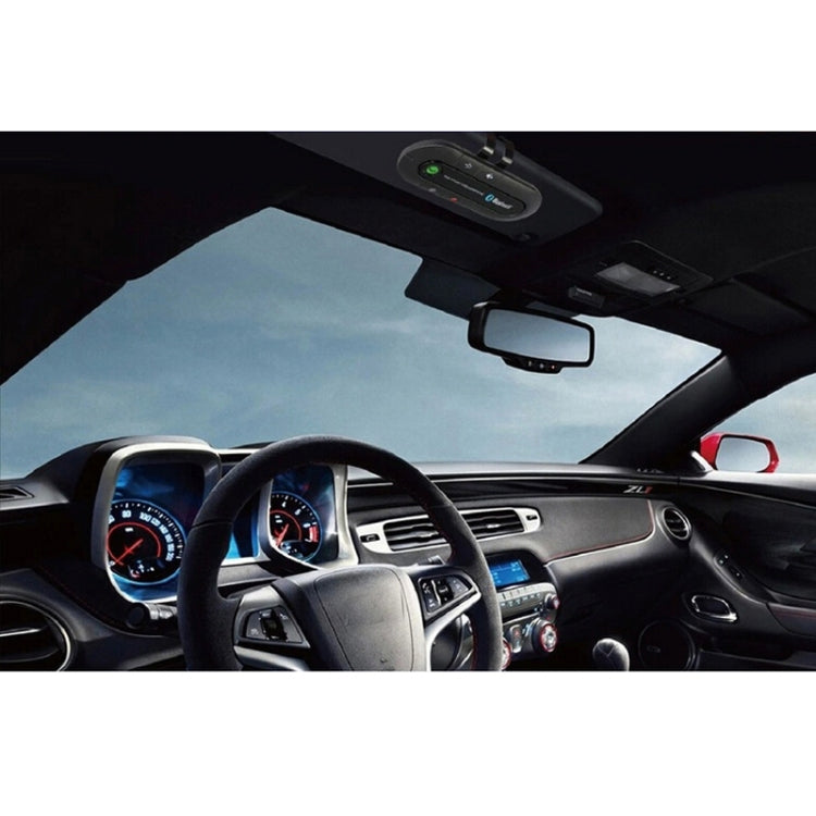 Bluetooth hands-free speakerphone transmitter mounted in car windshield area, black
