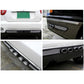 Black exhaust pipe decal on car bumper with chrome rings and mesh trim panel