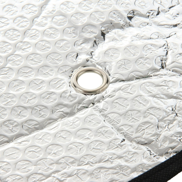 Silver reflective sunshade material with grommet eyelet detail for securing