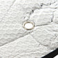 Rear windshield sunshade foil detail with round grommet on reflective silver fabric