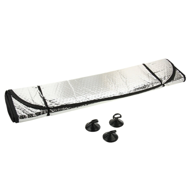 Folded rear windshield sunshade foil with black trim and small fastener pieces