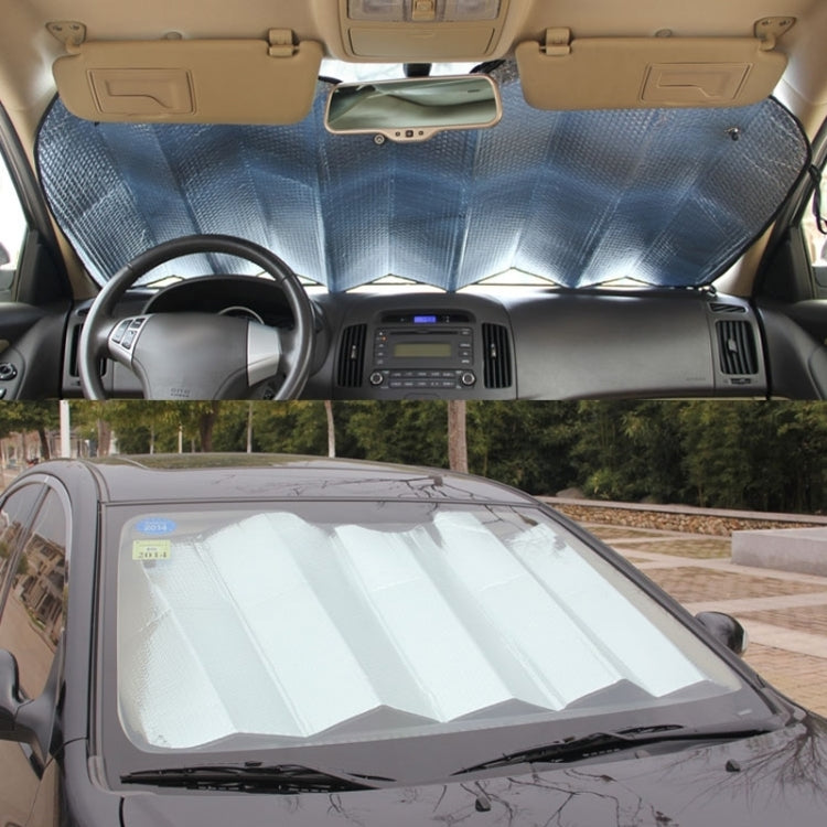 Rear windshield sunshade foil installed on car windshield, reflective silver coverage