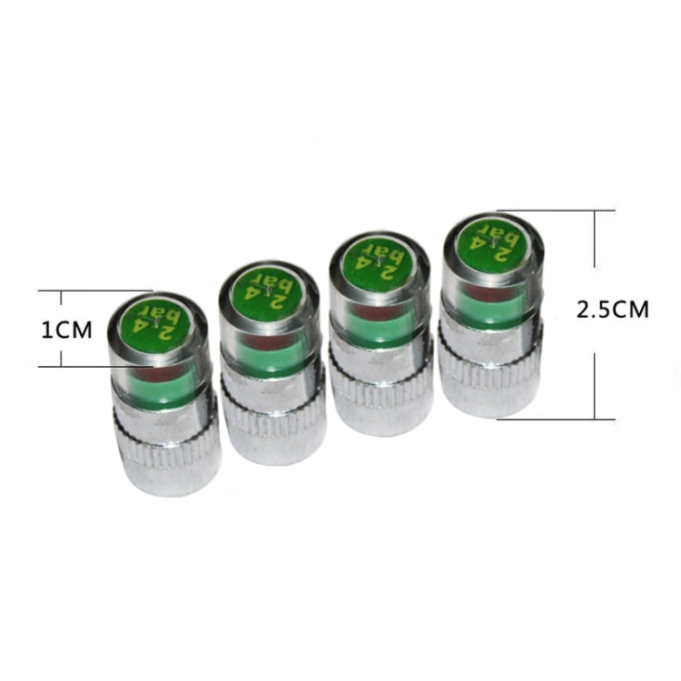 Four small chrome tire valve caps with green pressure indicator tops.