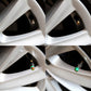Chrome tire valve caps with green pressure indicators installed on a wheel.