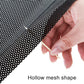 Perforated gray mesh sticker being pressed onto car window by hand