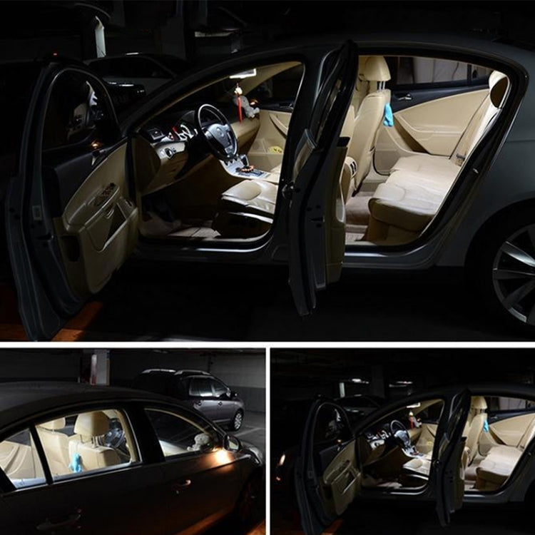 Car interior with overhead reading lights on near the open door