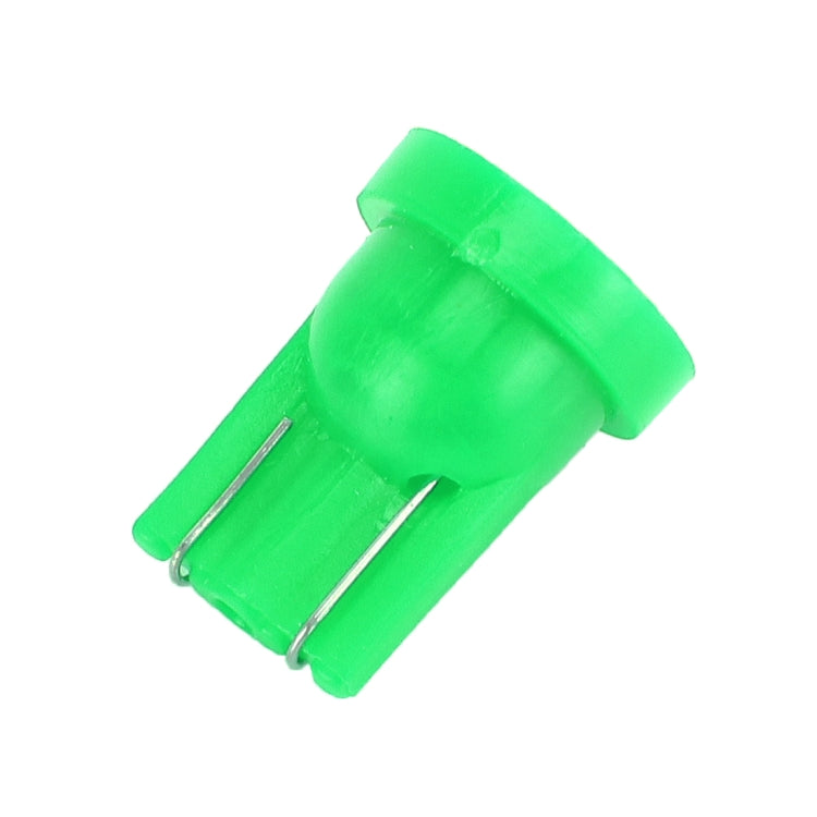 Green LED T10 car signal bulb with two metal pin prongs, close-up