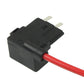 Black fuse tap holder with red wire connection and metal blade pins