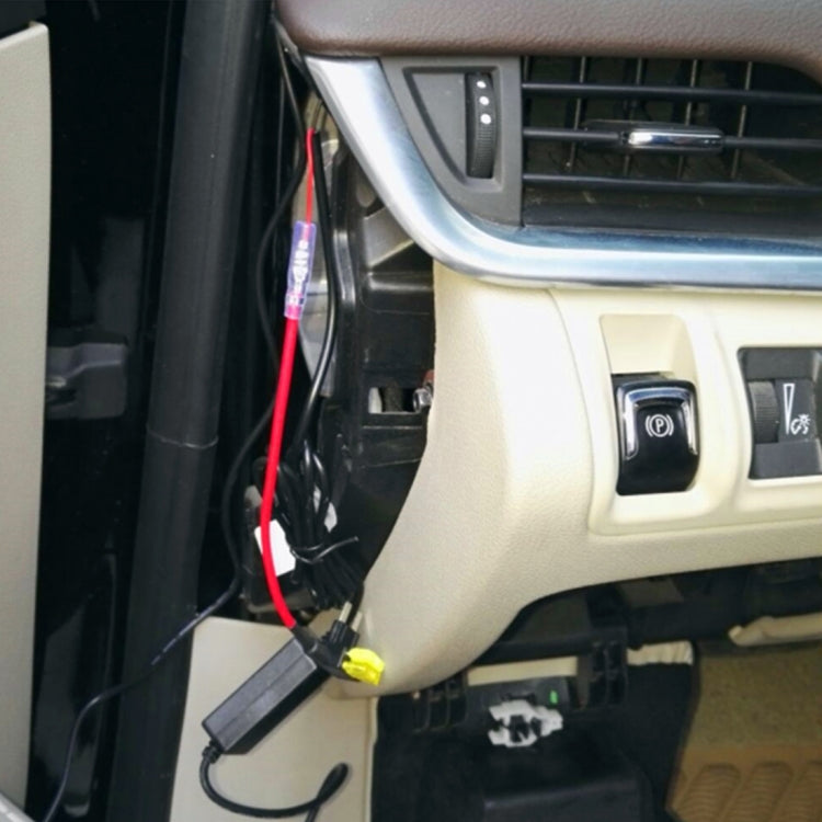 Adapter fuse tap installed near dashboard fuse panel with red lead and black module