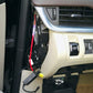 Auto fuse tap adapter with red wire connected near vehicle interior panel