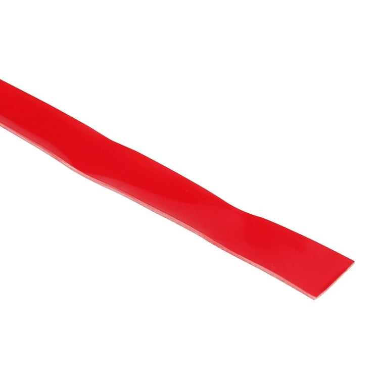 Red adhesive tape strip with smooth top surface and straight cut edge
