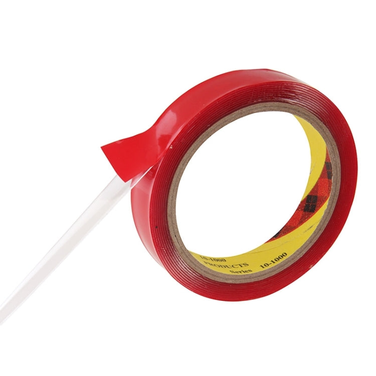 Red double-sided adhesive tape roll with tape end pulled out, close-up