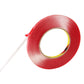 Red double-sided adhesive tape roll with tape end pulled out