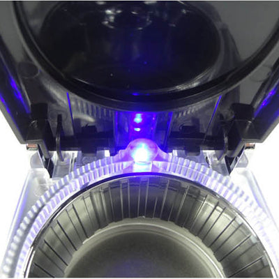 Close-up of LED-lit interior inside an ashtray, with blue light glowing at the rim
