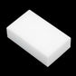 White rectangular cleaning sponge block, solid shape with smooth edges.