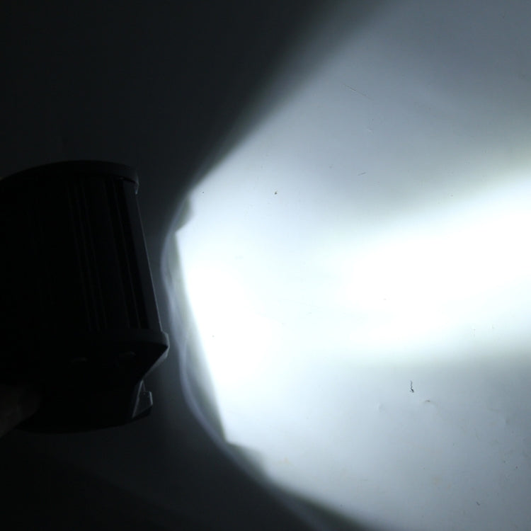 White LED light beam projecting in a dark area.