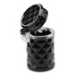 Black diamond-pattern car ashtray with open lid and silver inner ash holder