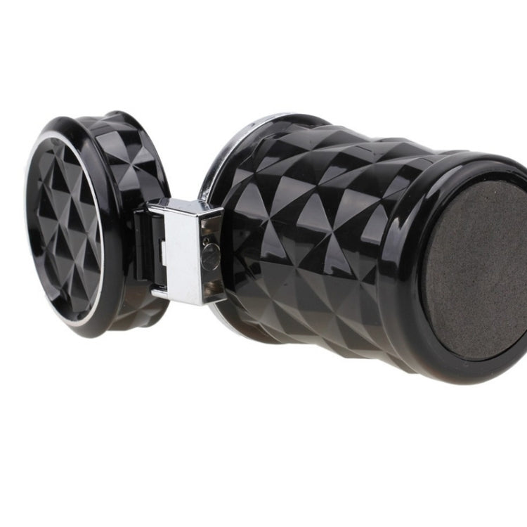 Black diamond-pattern car ashtray with hinged lid and round base, shown in profile