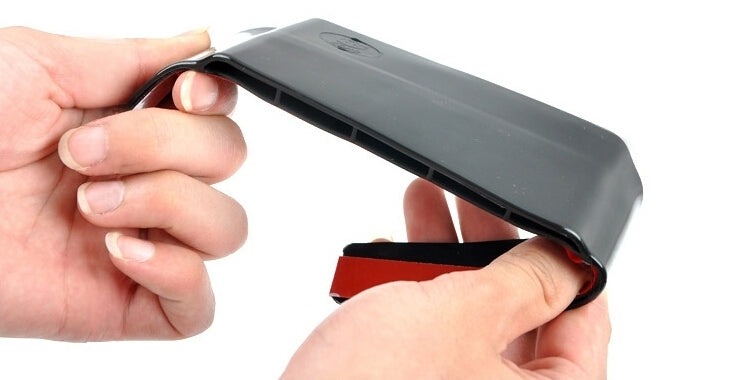 Flexible rearview mirror rain deflector being installed by hand, black shield